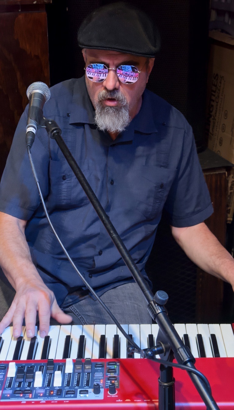 Musician playing keyboard with microphone